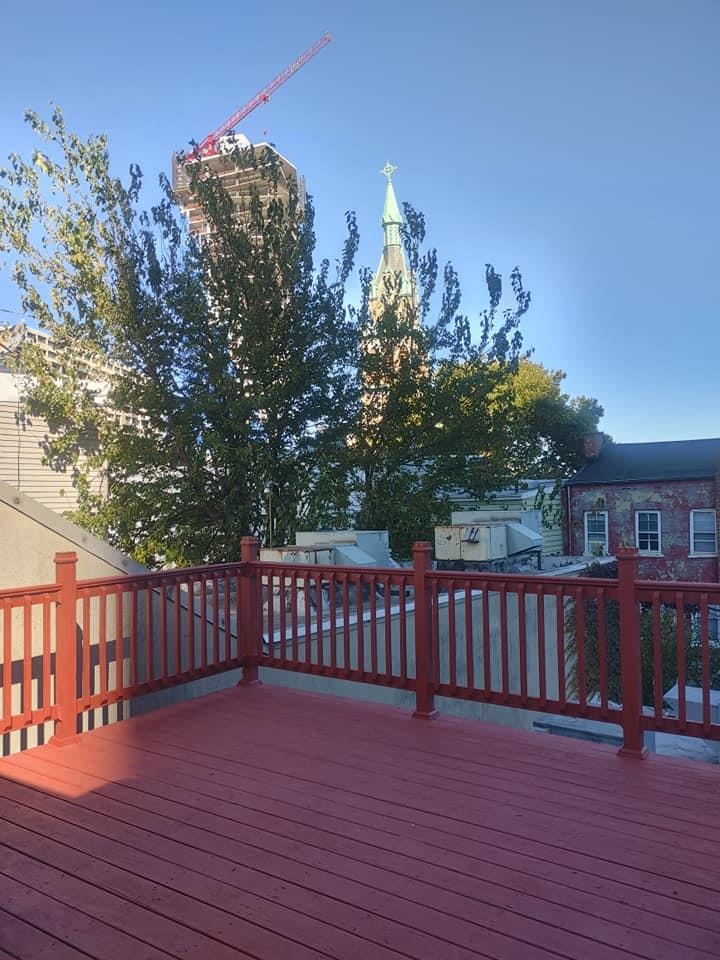 a view of a deck and a yard with wooden fence