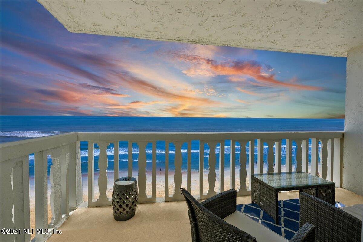 a roof deck with table and chairs