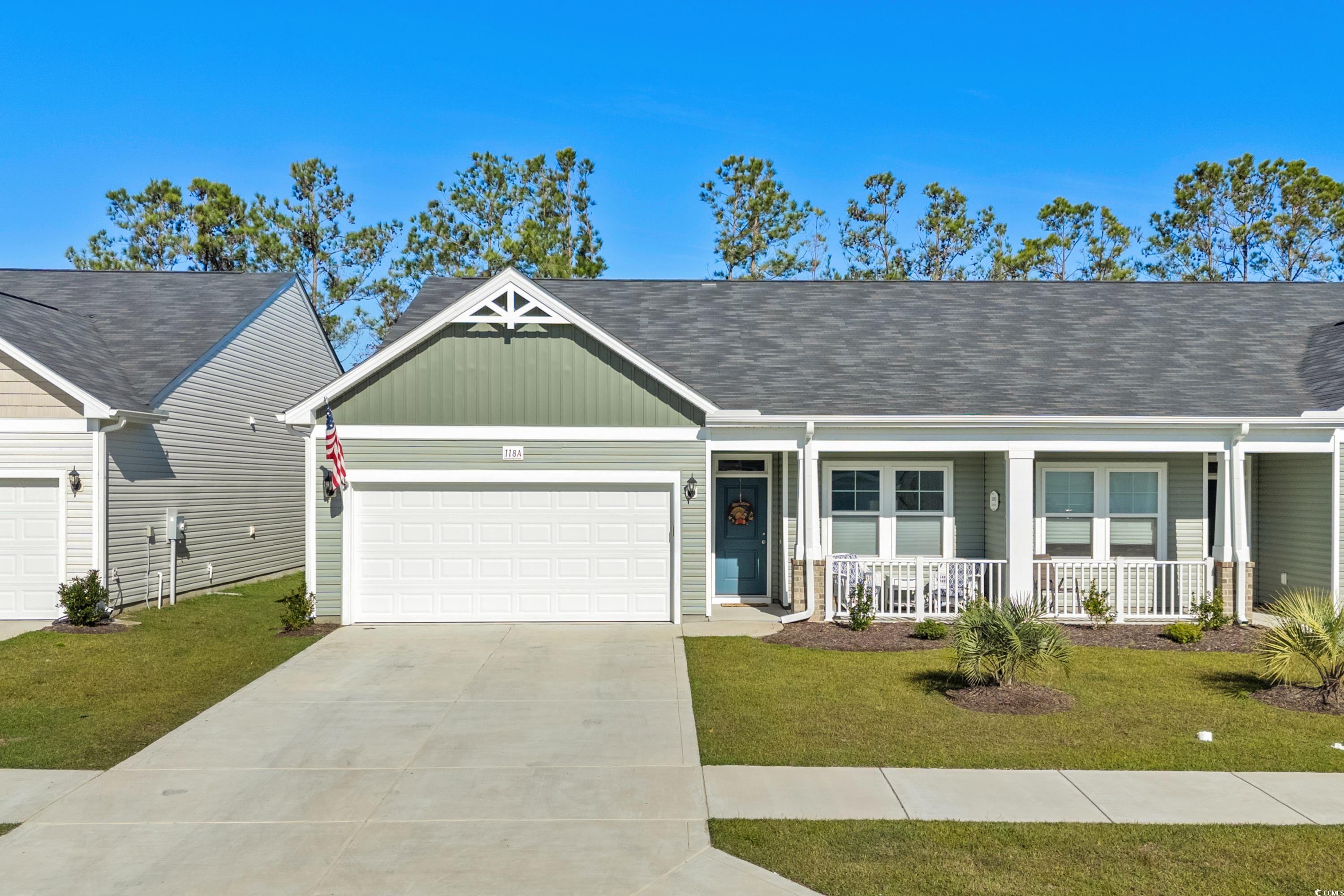 Ranch-style home with covered porch, a garage, and