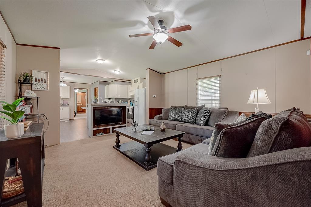 a living room with furniture fireplace and a flat screen tv