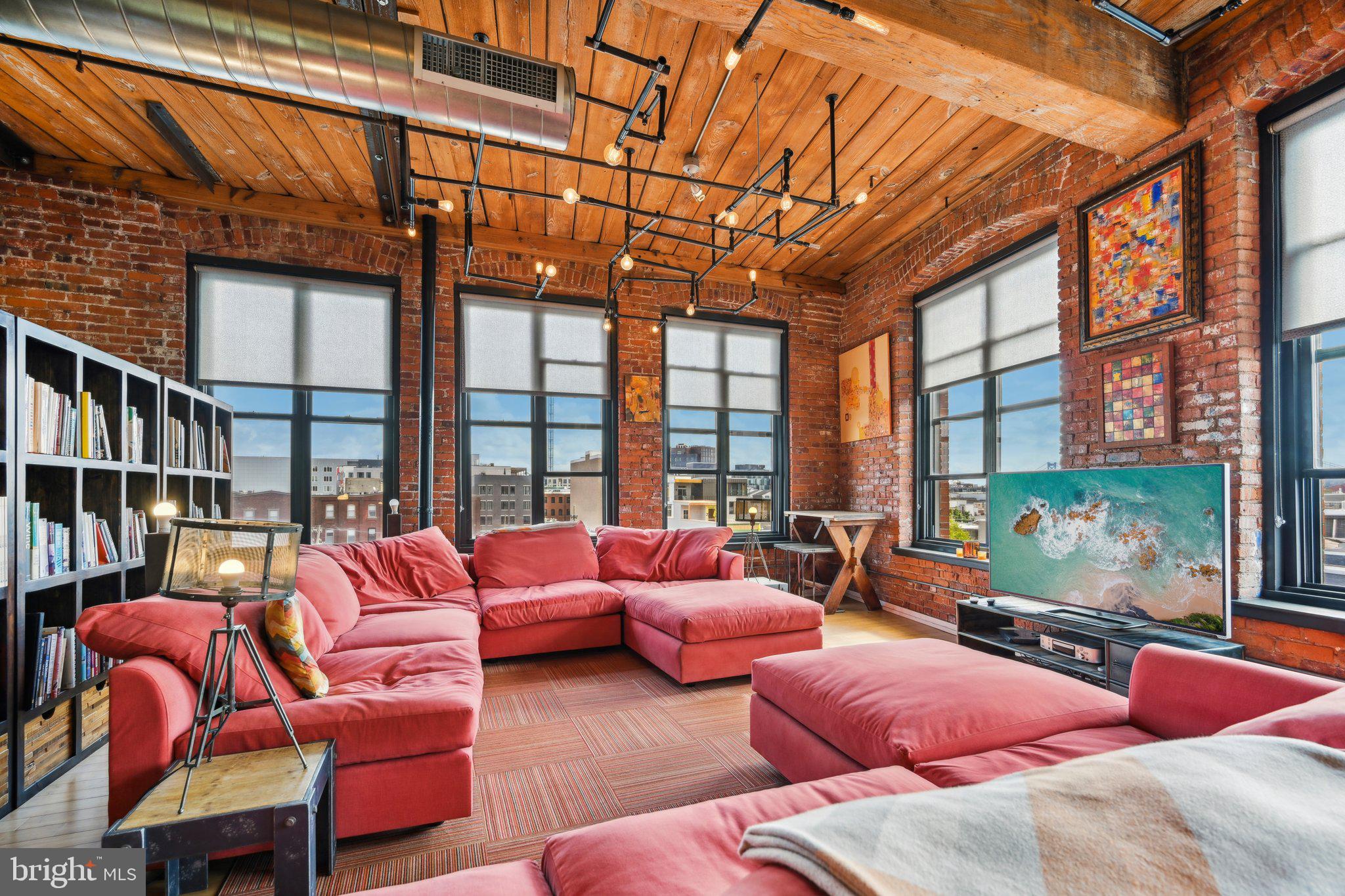 a outdoor living room with furniture and a large window