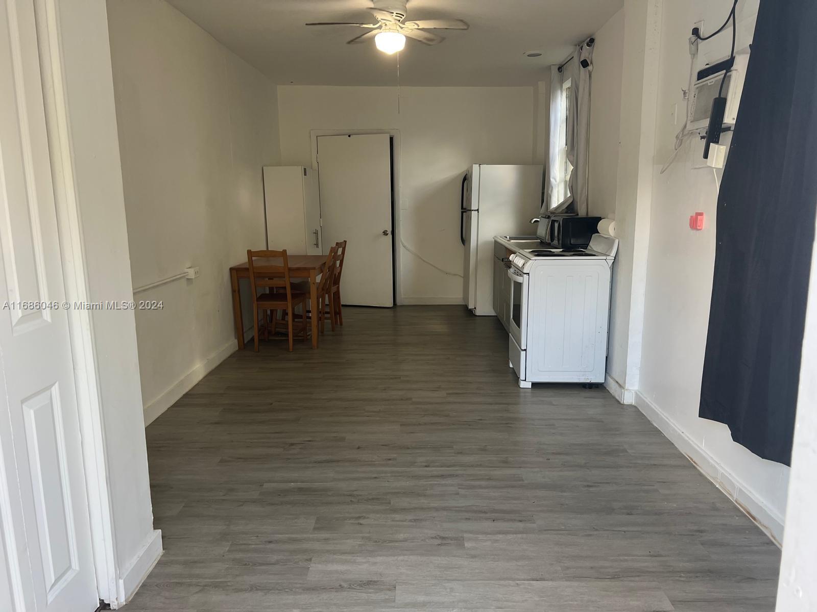 a view of kitchen with furniture and wooden floor