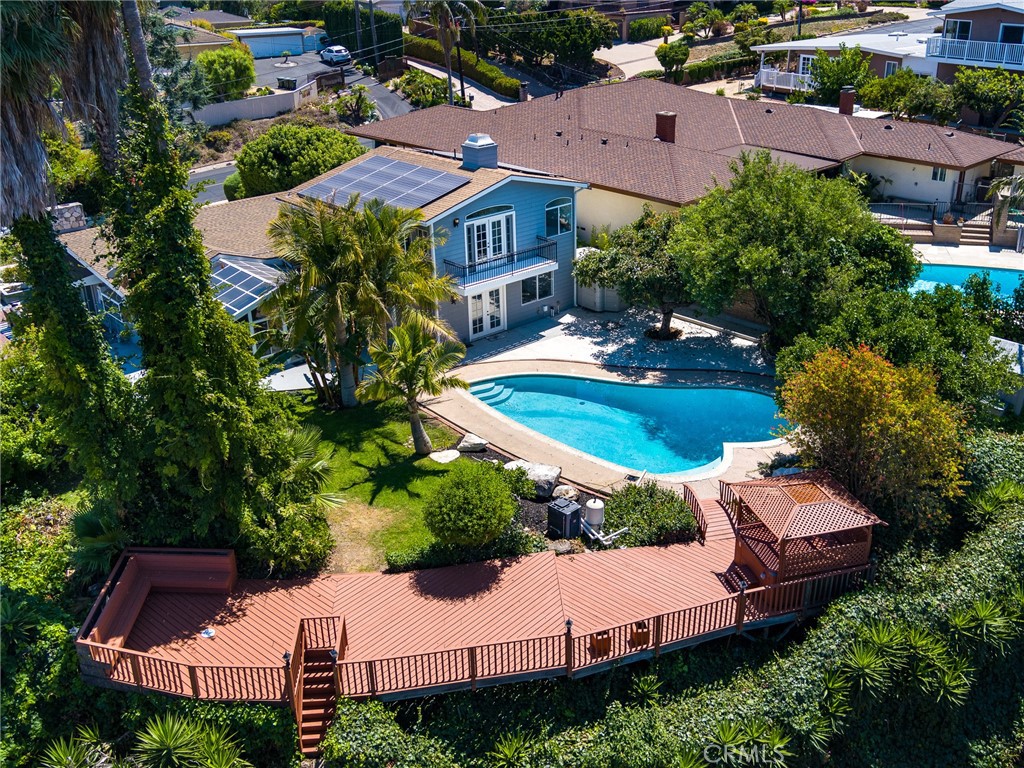 an aerial view of a house with garden space and street view