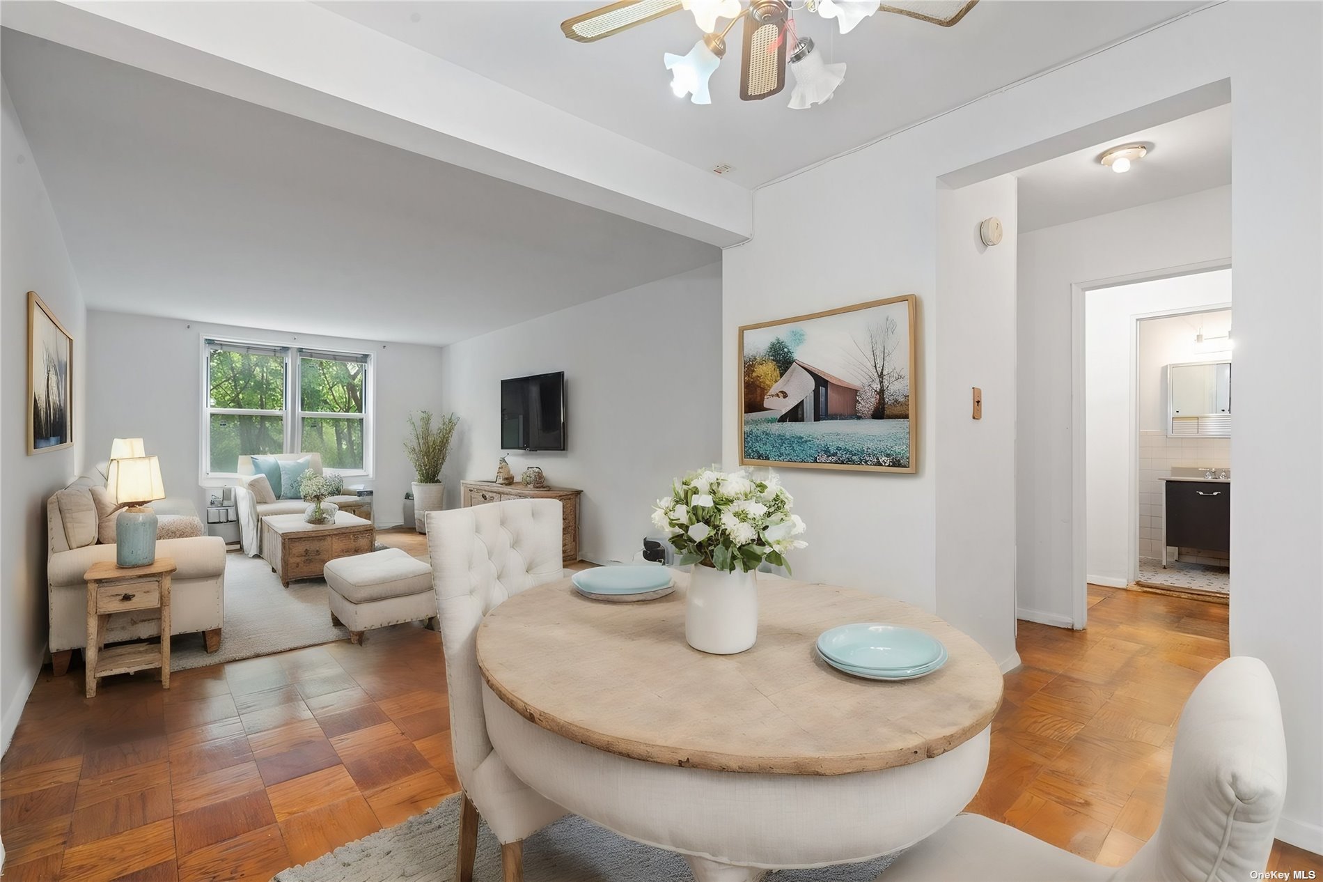 a living room with furniture and a chandelier