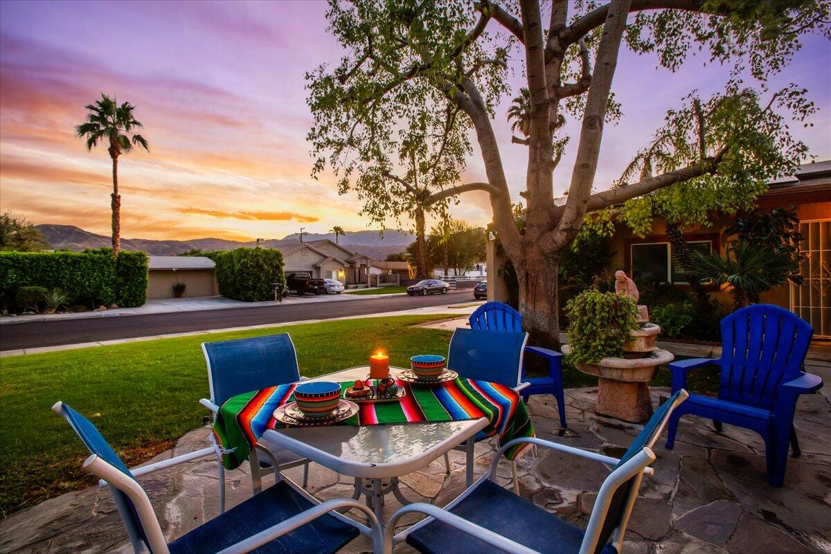 a view of a chairs and table in patio with a lake view