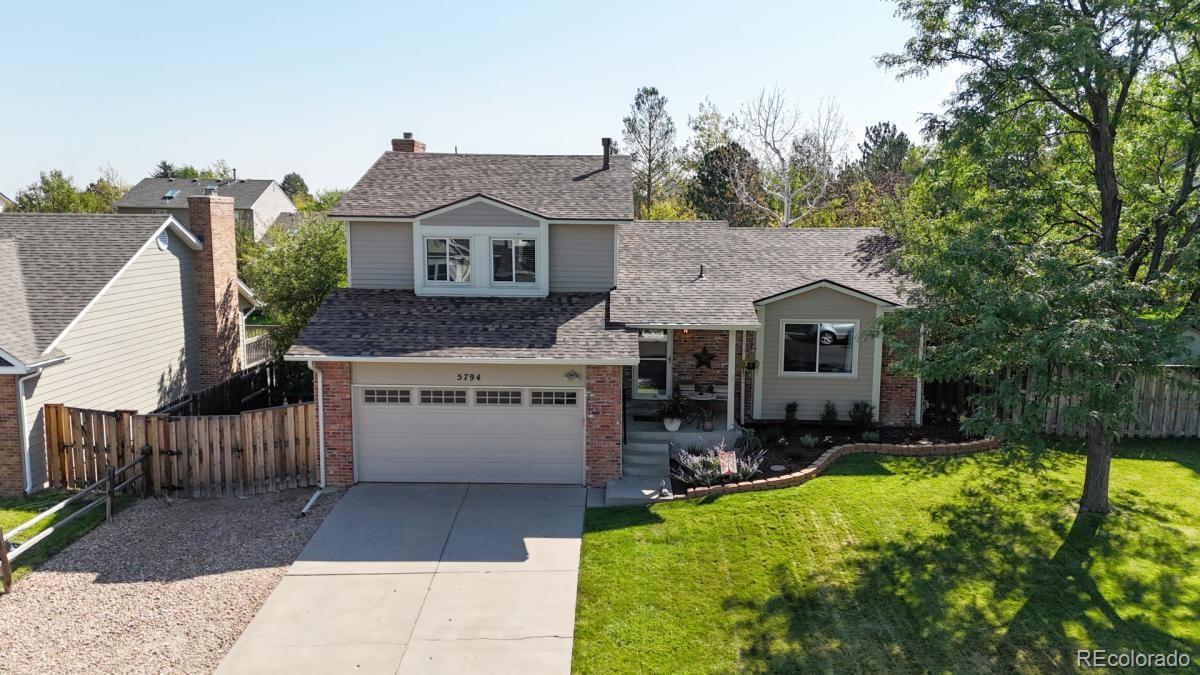 a view of house with outdoor space and sitting area