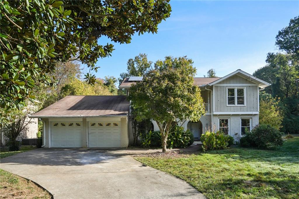 a view of a house with a yard and tree s