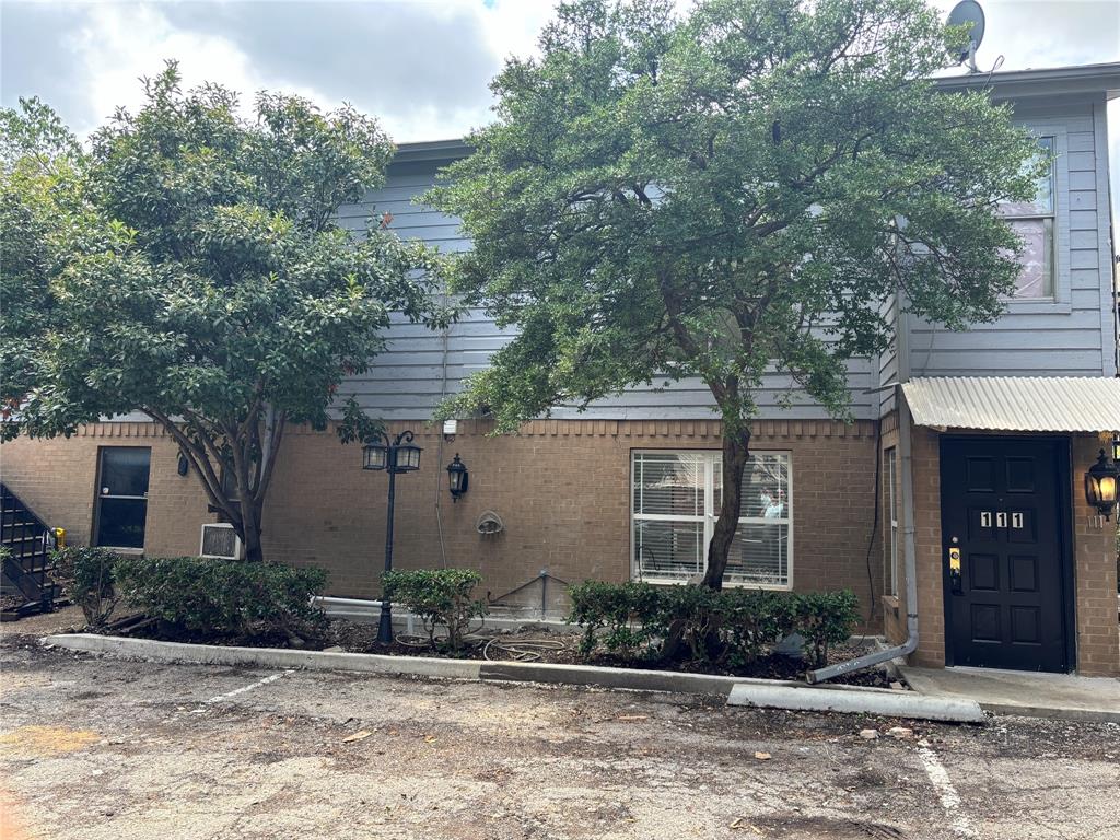 a front view of a house with a yard and potted plants