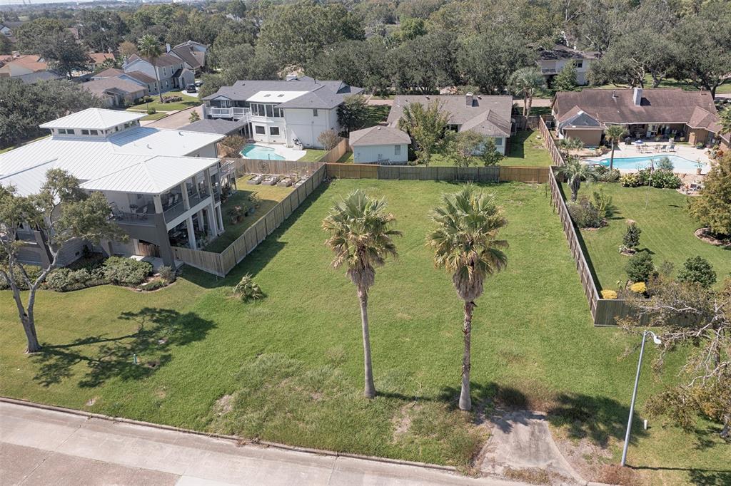 an aerial view of a house with a yard basket ball court