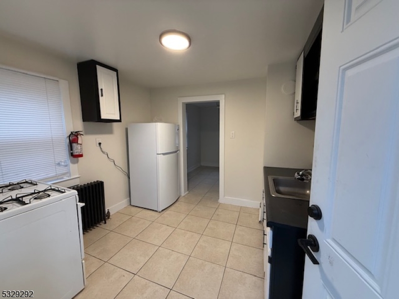 a kitchen with a refrigerator and a stove