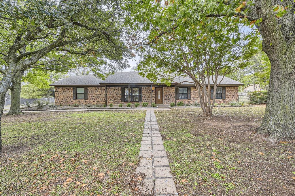 Ranch-style home with large trees & covered porch