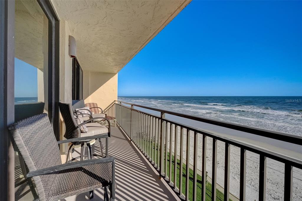 a view of a balcony with chairs