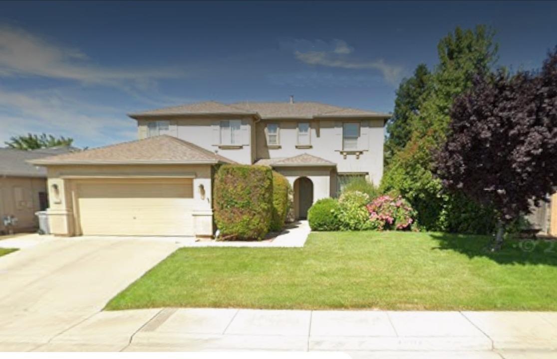 a house view with a garden space