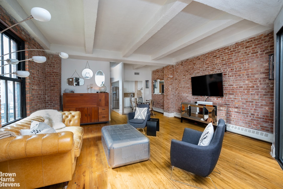 a living room with fireplace furniture and a flat screen tv