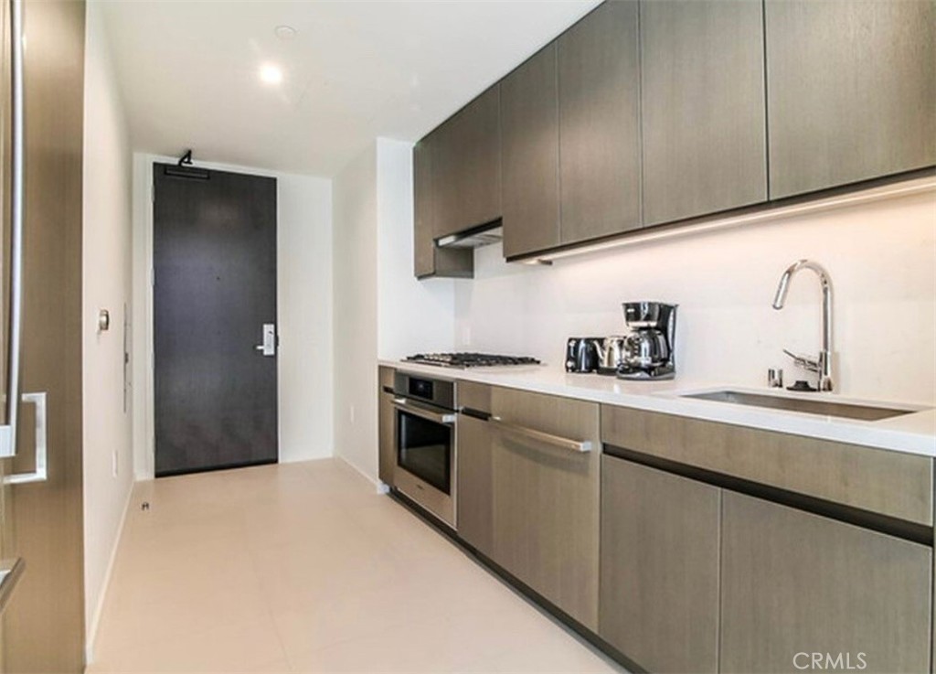 a kitchen with cabinets and stainless steel appliances