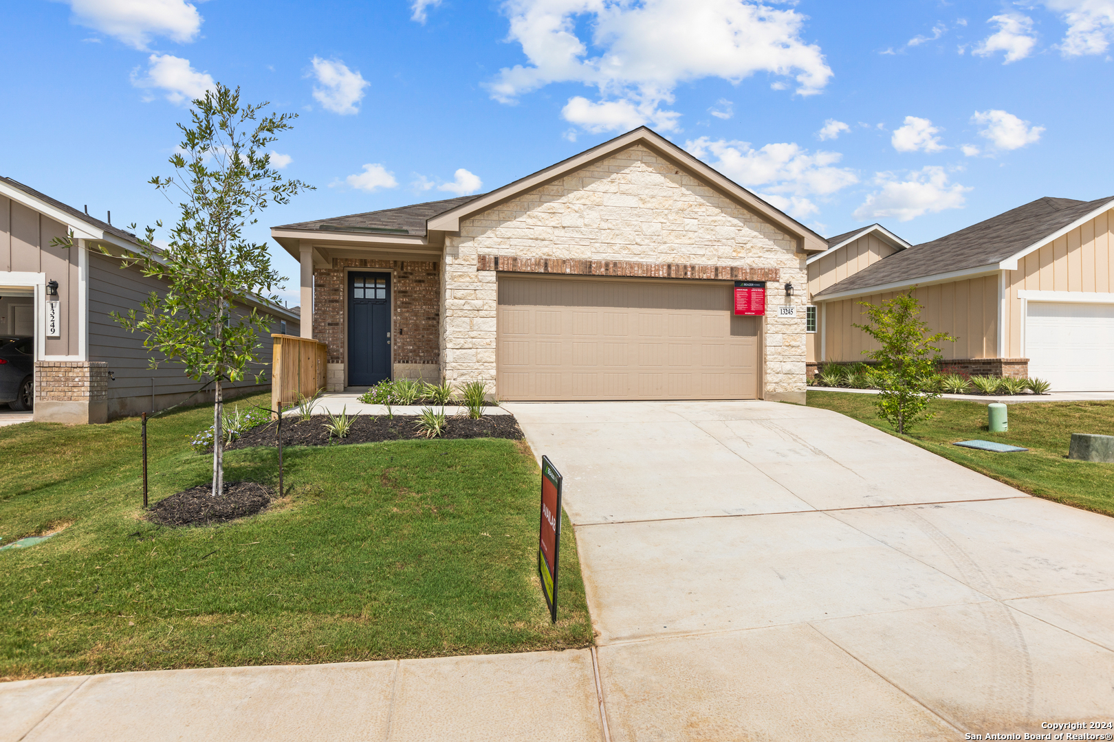 a front view of a house with a yard and garage