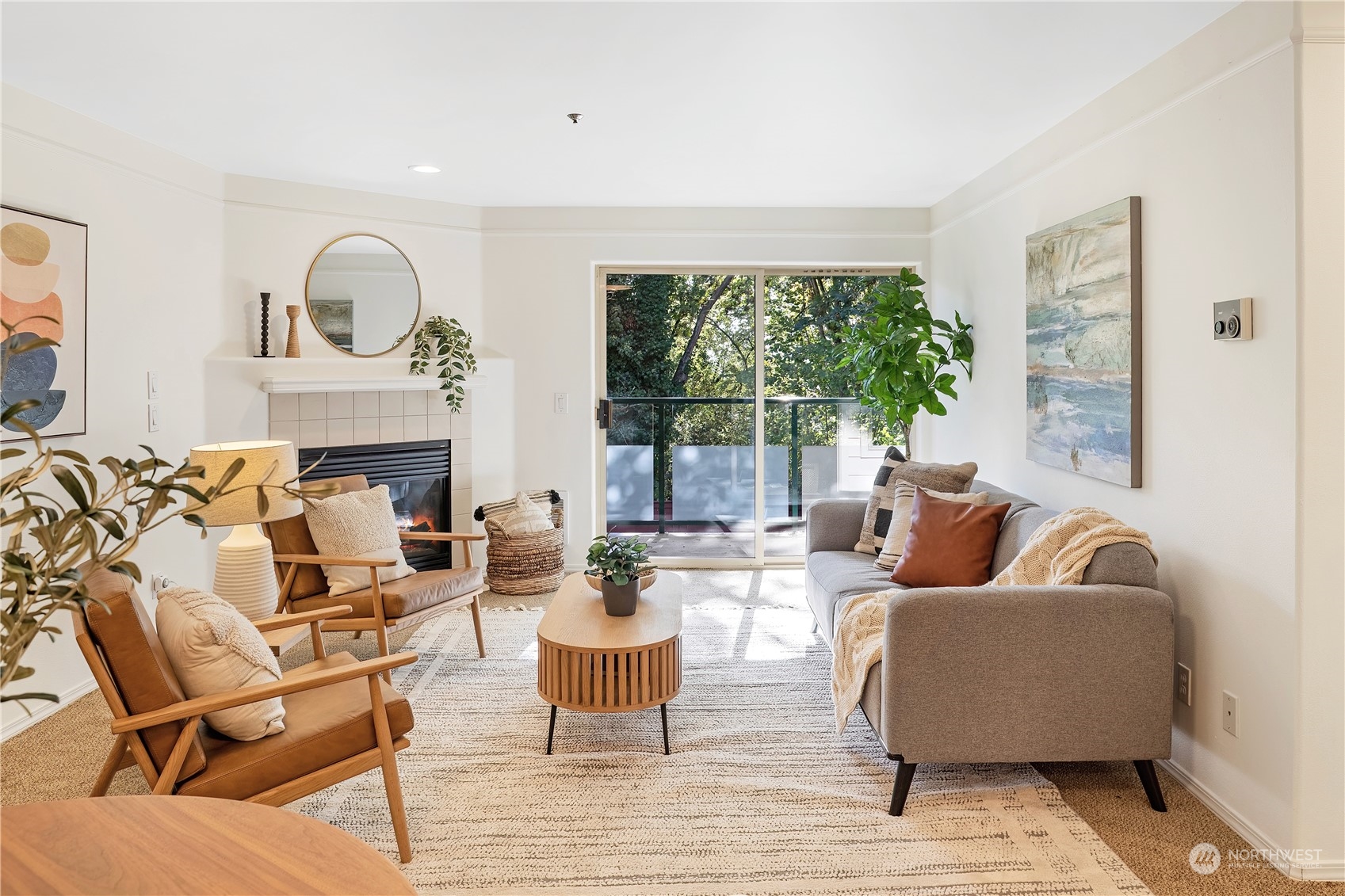 a living room with fireplace furniture and a large window