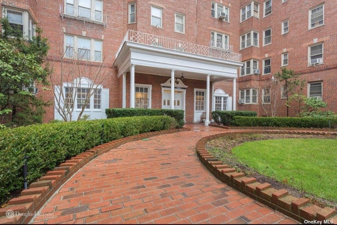 a view of a building next to a yard