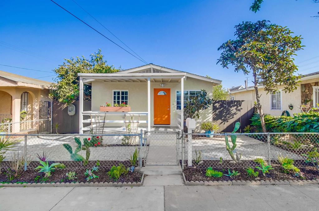 front view of a house with potted plants