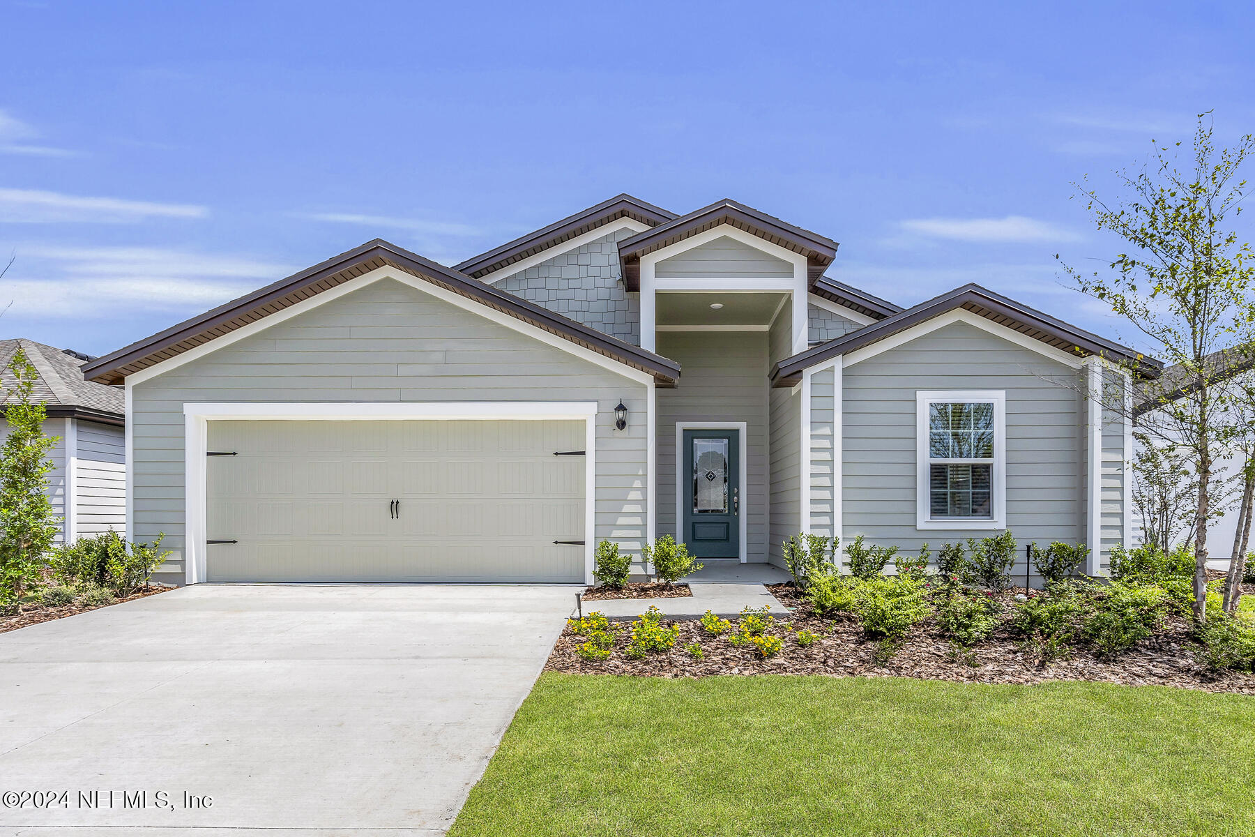 a front view of house with yard and green space