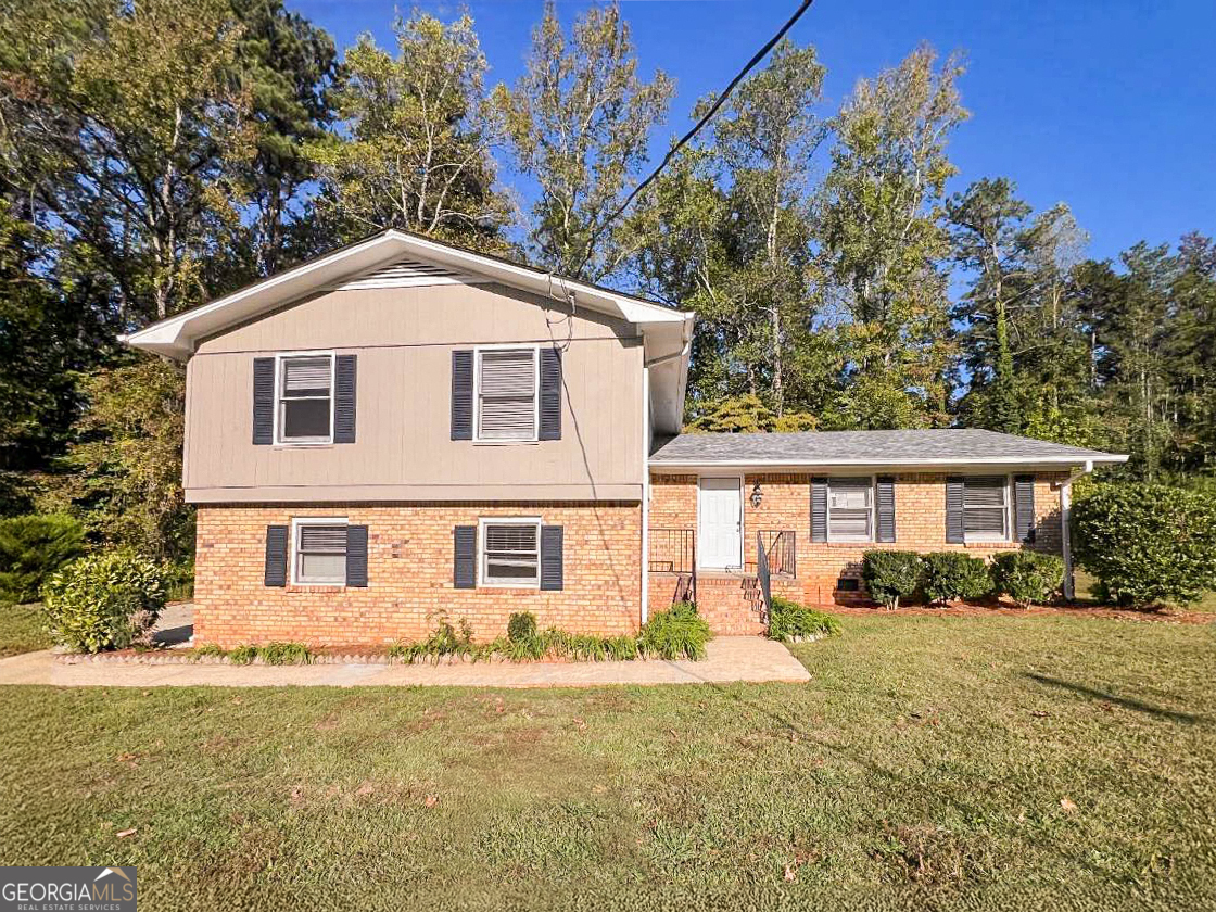 a front view of a house with a yard