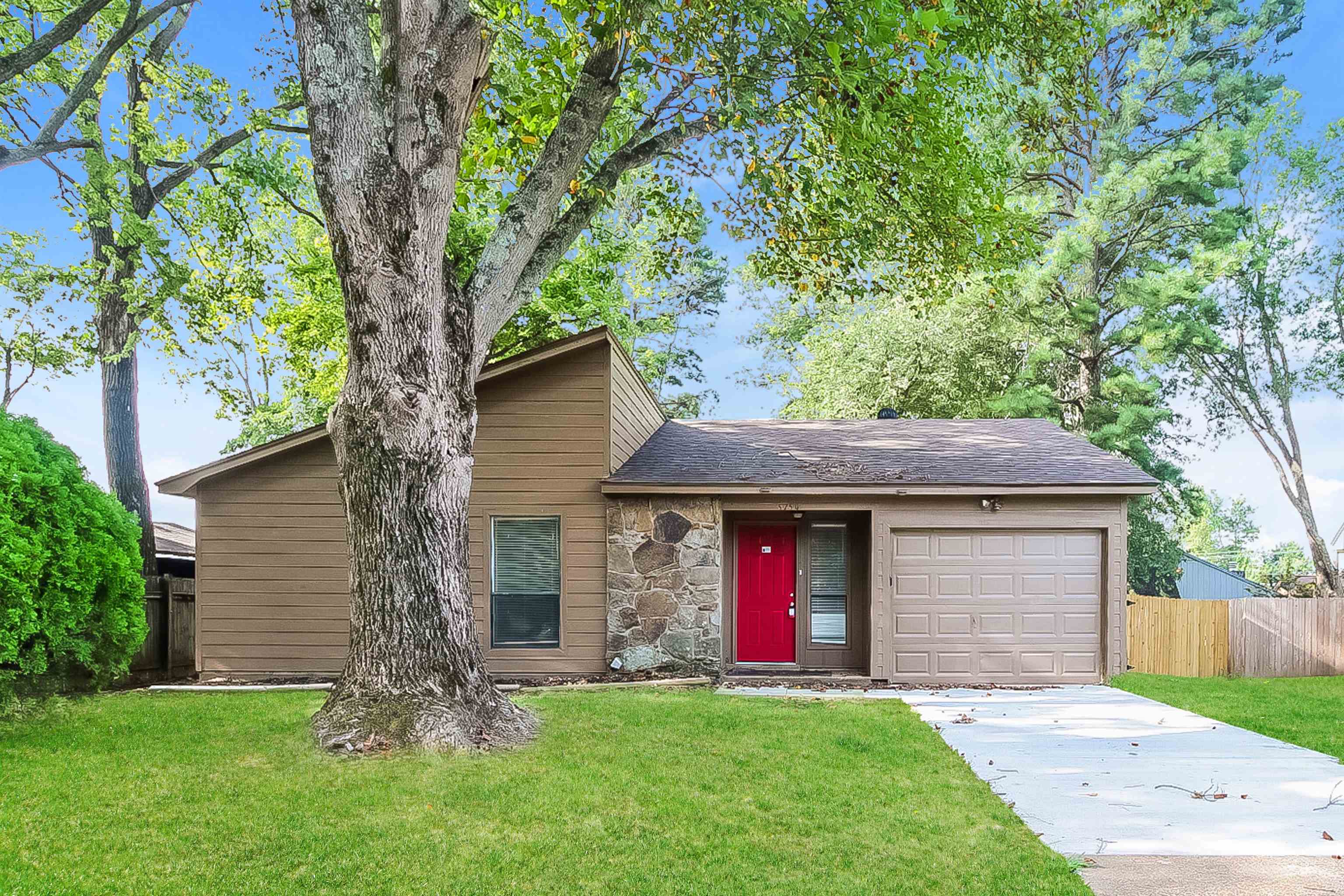 View of front of house featuring a garage and a front lawn