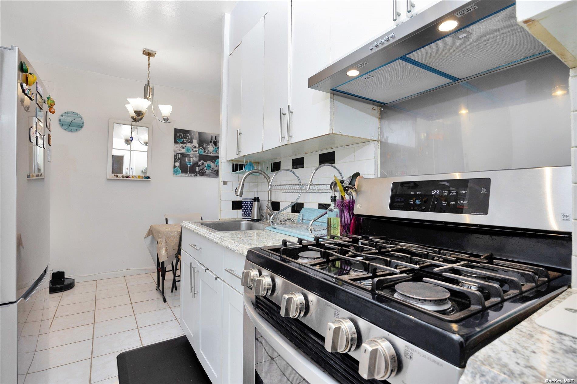 a kitchen with a stove and a wooden floor