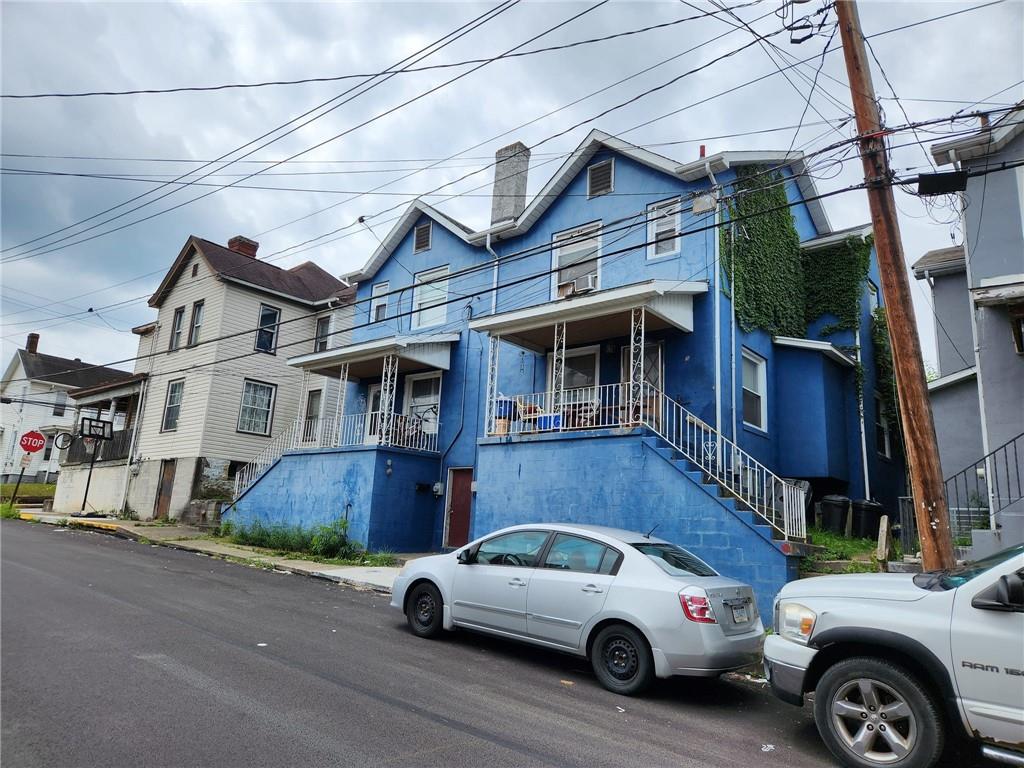 a view of a car parked in front of a house