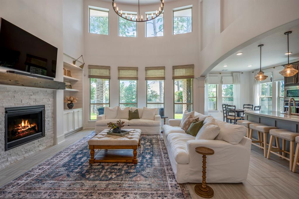 a living room with furniture fireplace and flat screen tv