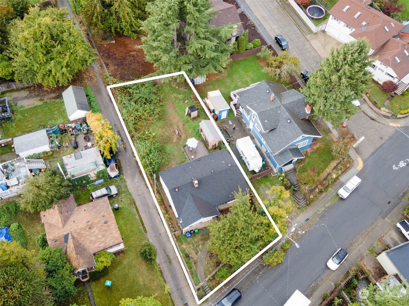 an aerial view of a house with a garden and trees