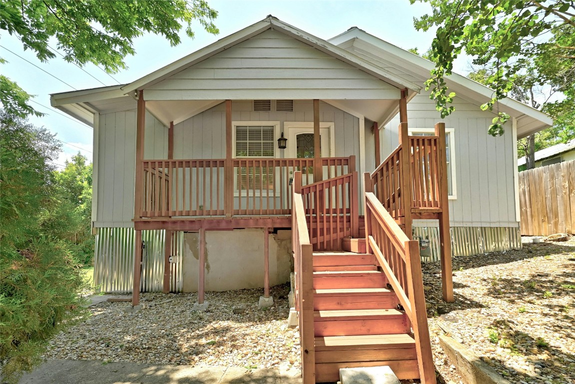 a view of a house with wooden floor next to a yard