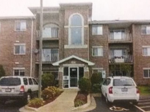 a front view of a house with parking space