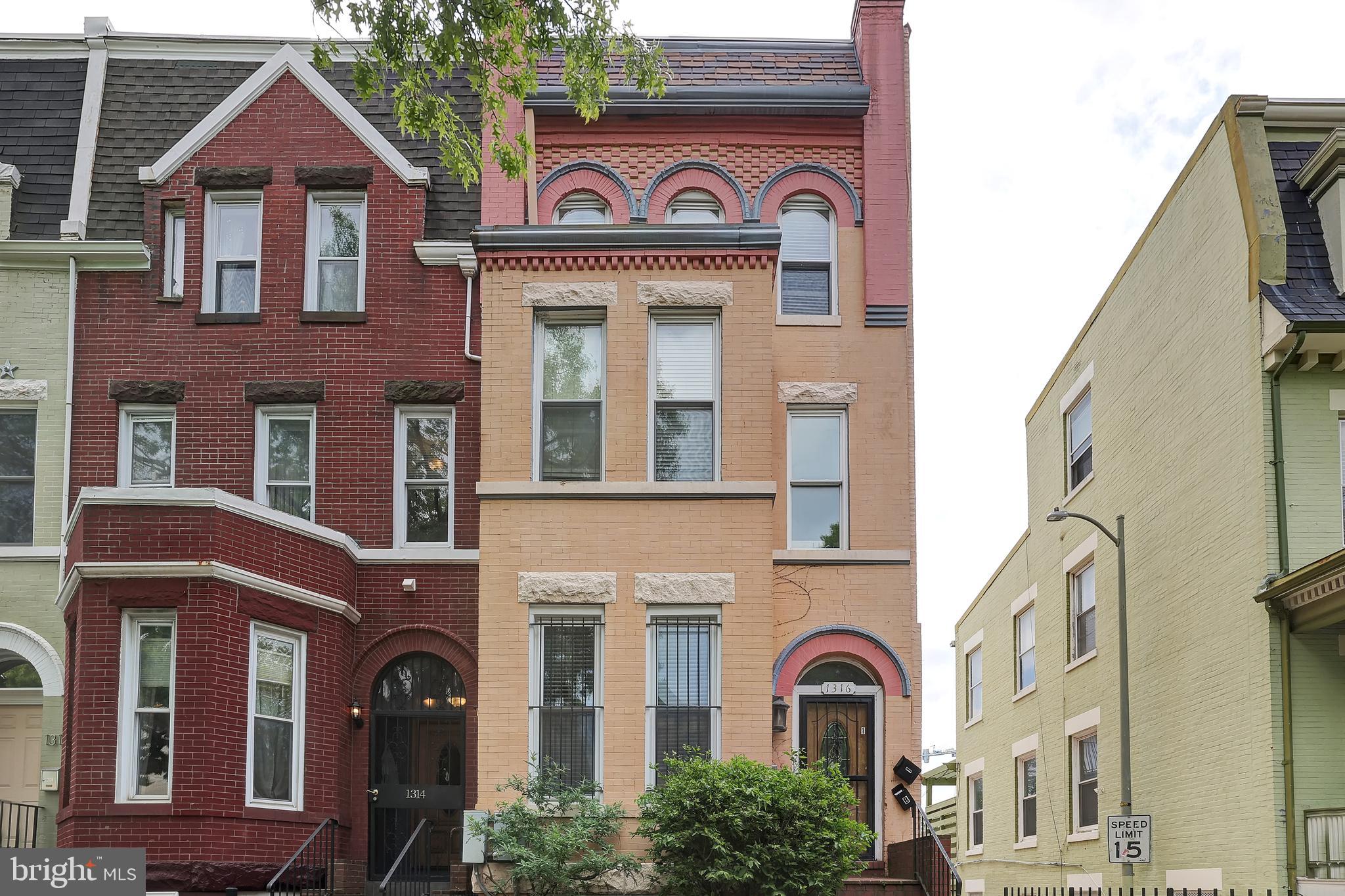 a view of a brick house with large windows