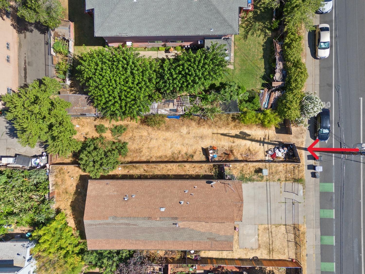 an aerial view of a house with a yard and large trees