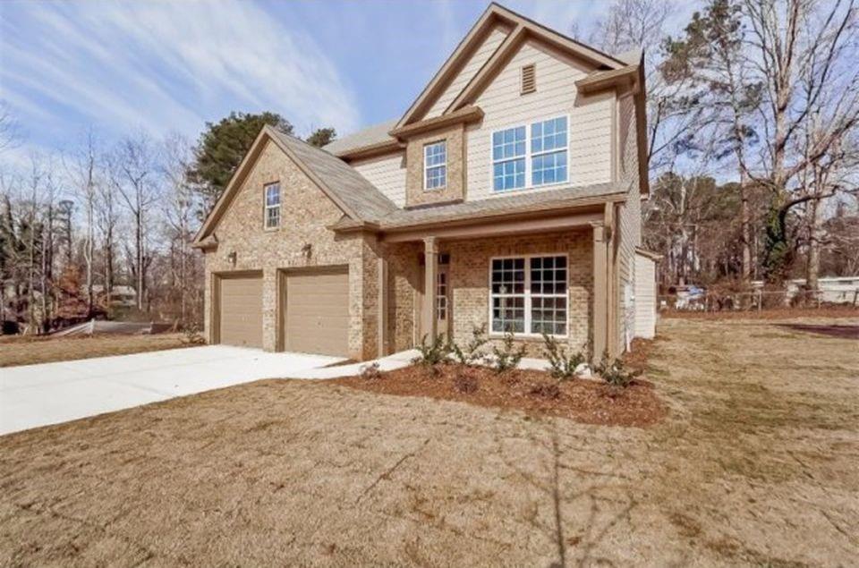 a front view of a house with a yard and garage