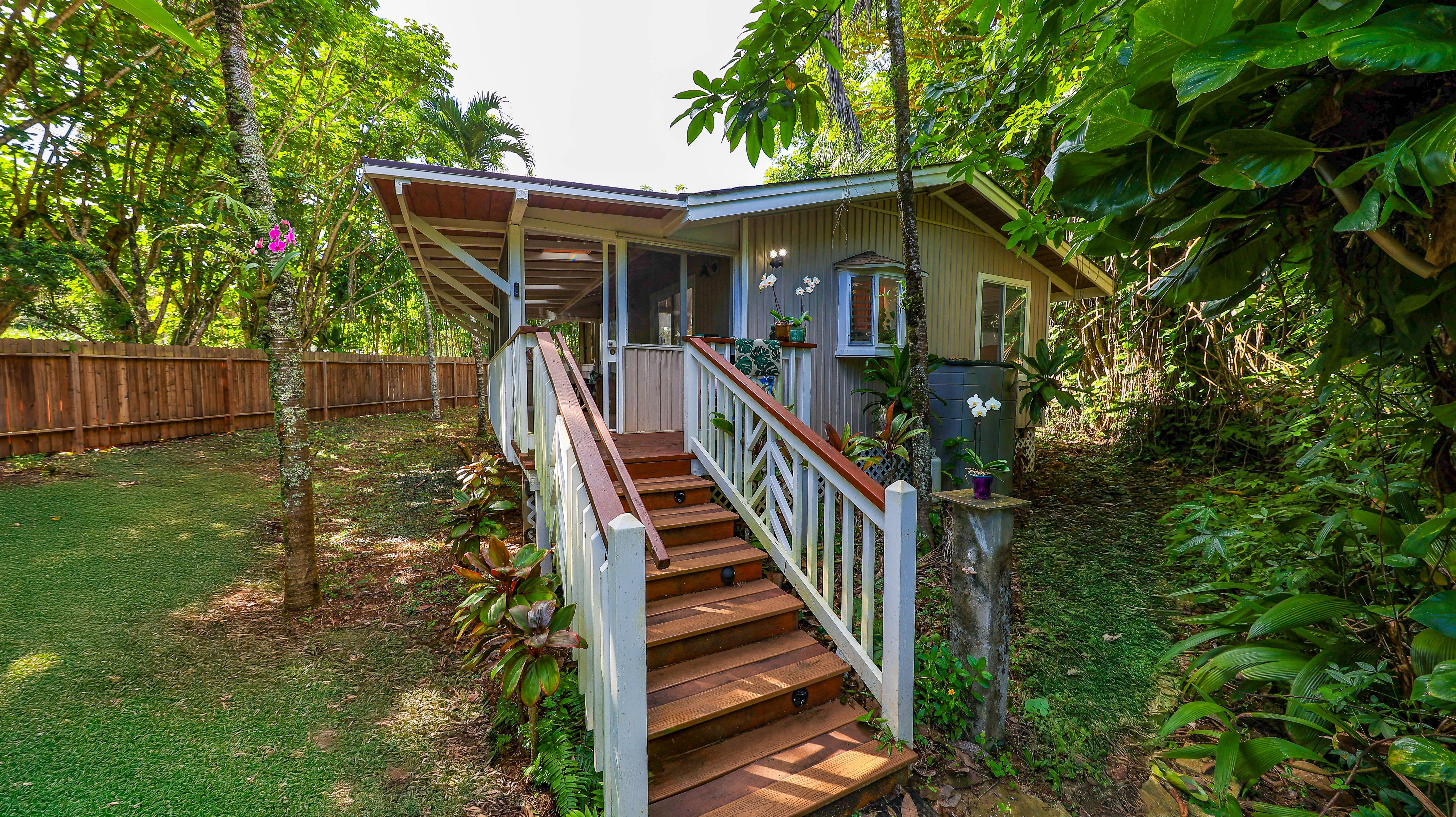 a view of house with swimming pool and deck