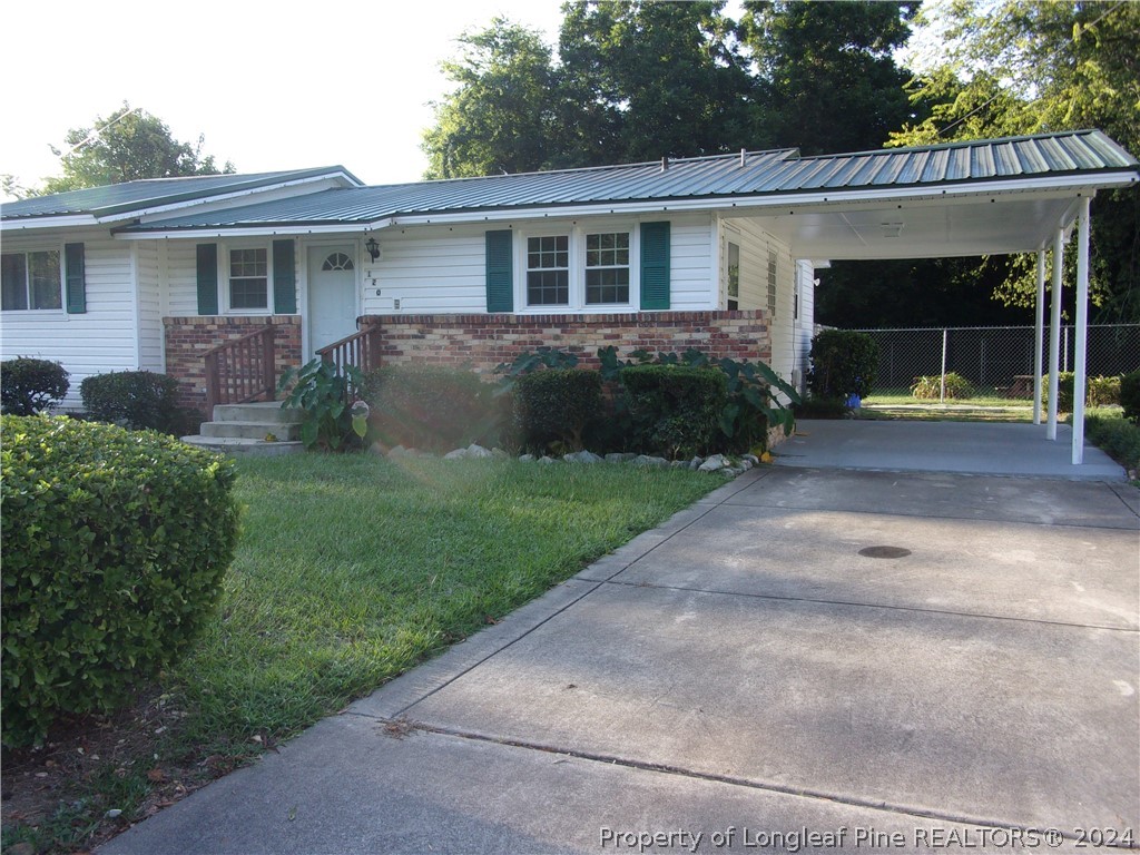 a view of house with a yard