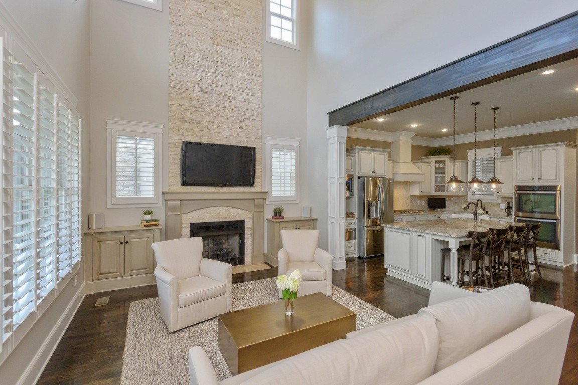 a living room with furniture a fireplace and a flat screen tv