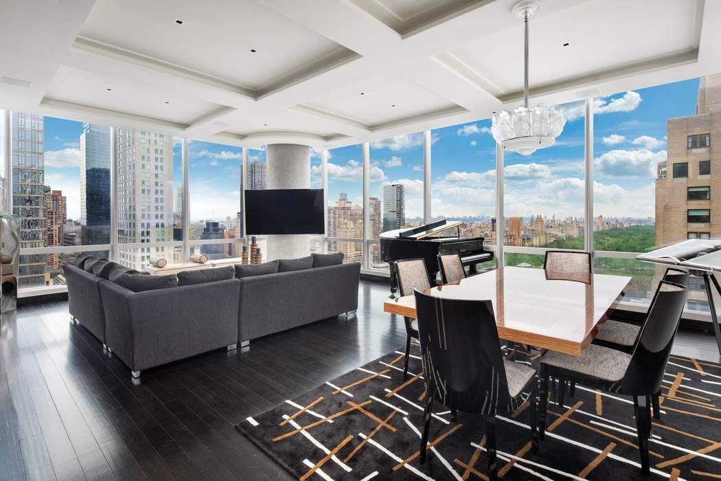 a living room with patio furniture and a flat screen tv