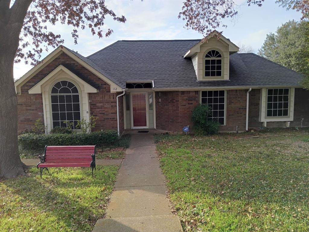 a front view of a house with yard