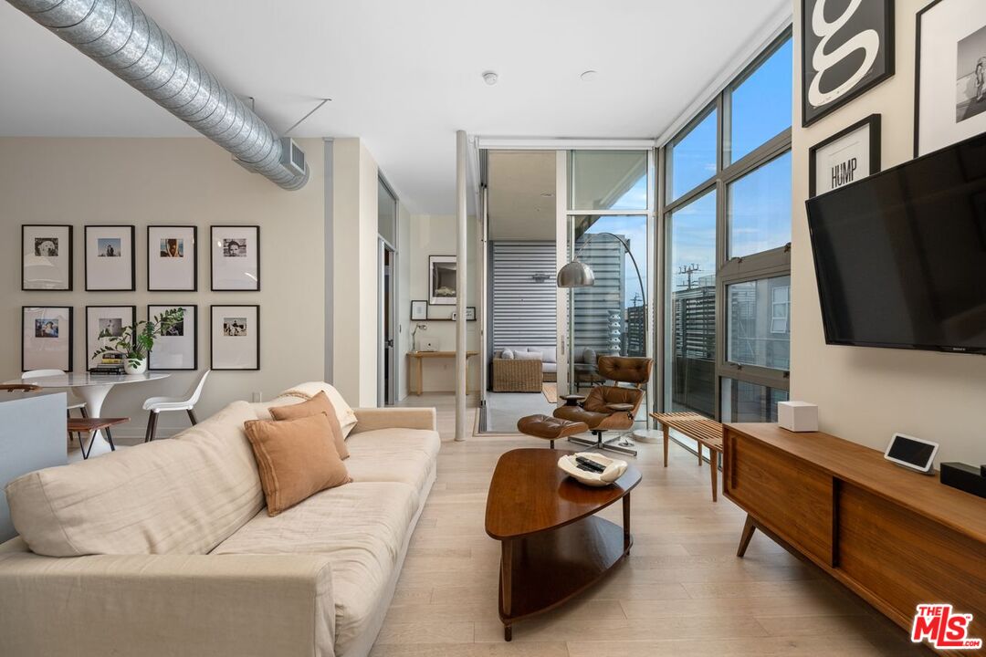 a living room with furniture fireplace and flat screen tv