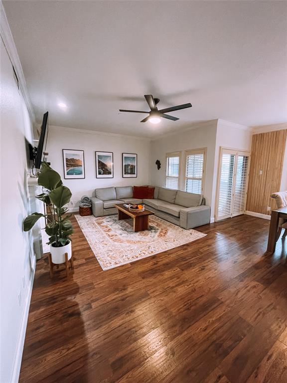 a living room with furniture and a wooden floor