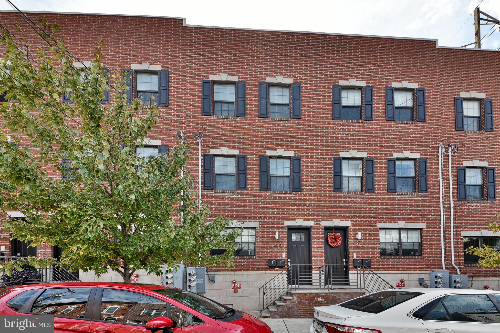 a front view of a building with trees