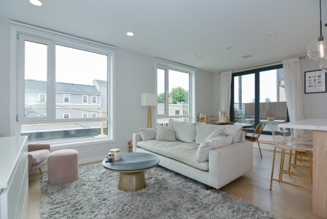 a living room with furniture and a large window