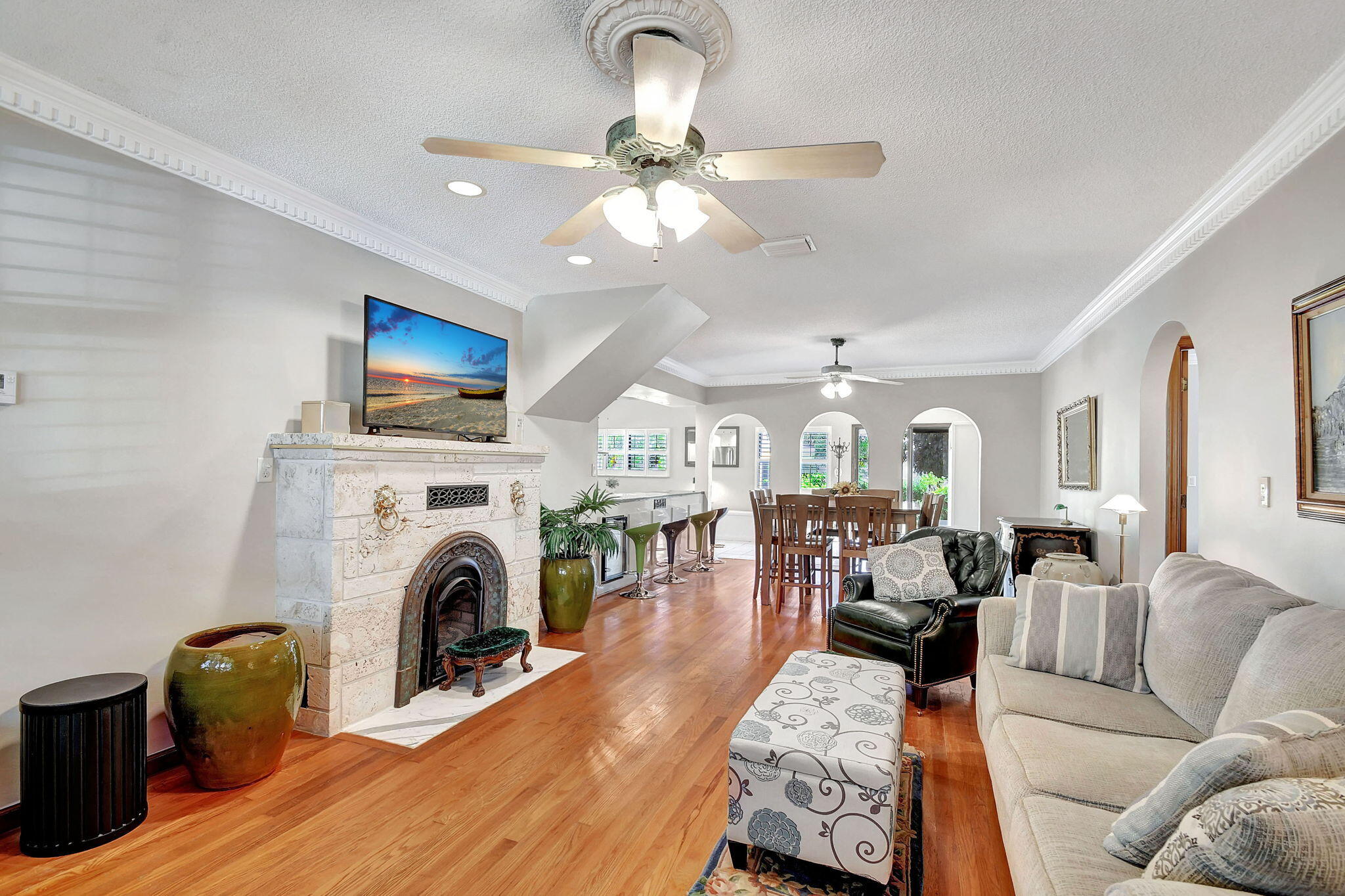 a living room with furniture a fireplace and a flat screen tv