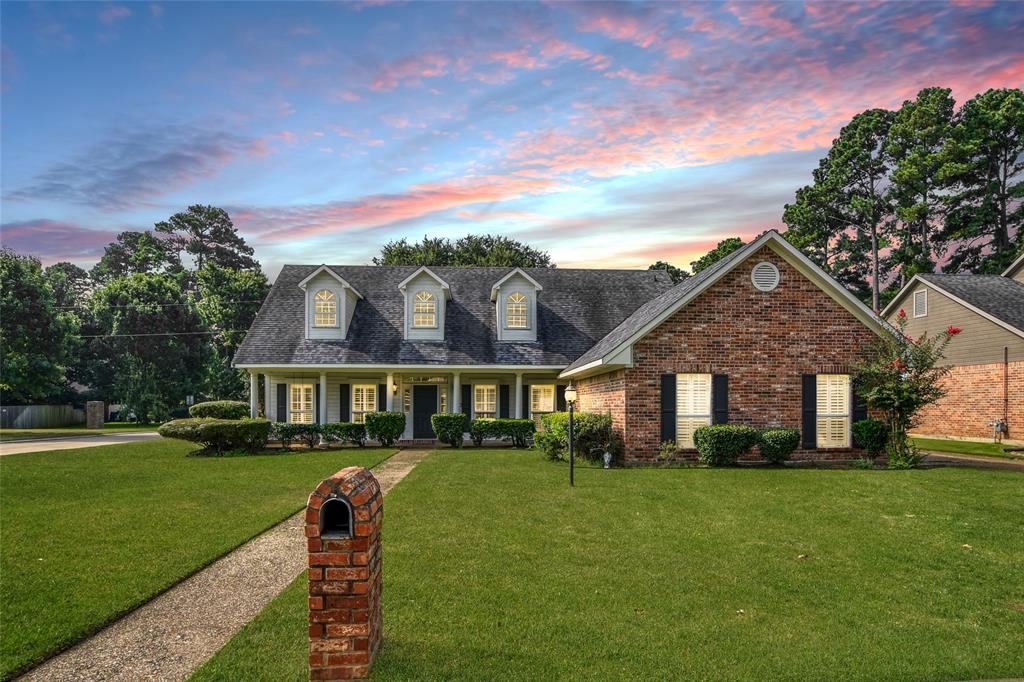 a front view of house with yard and green space