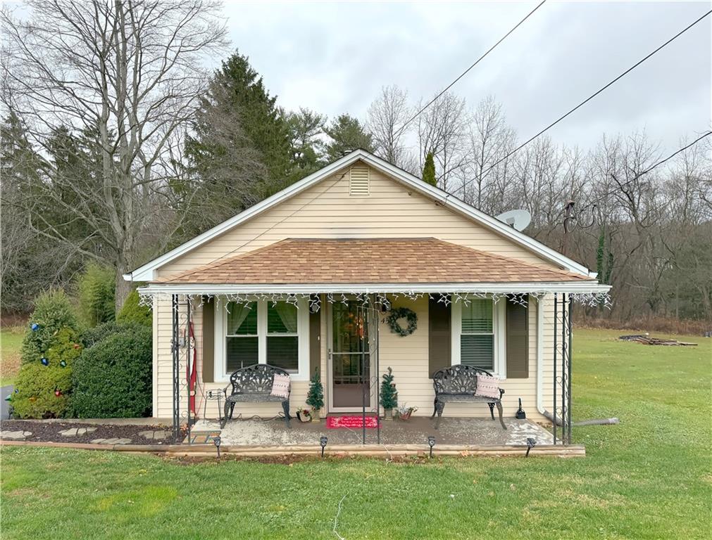 a front view of house with yard and outdoor seating