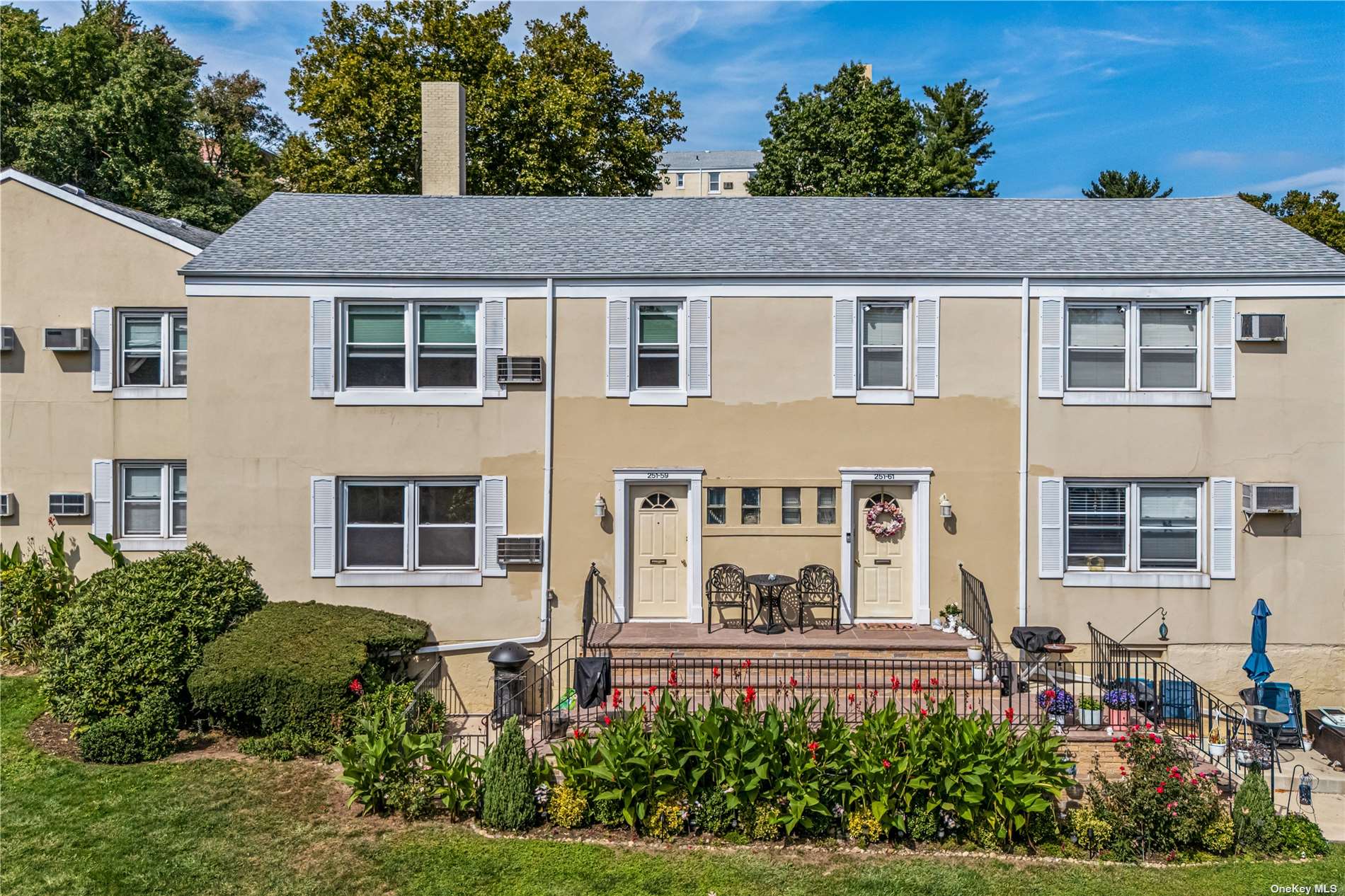 a aerial view of a house with a yard and potted plants