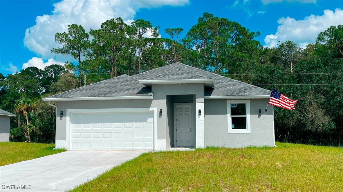 a front view of a house with a yard and garage