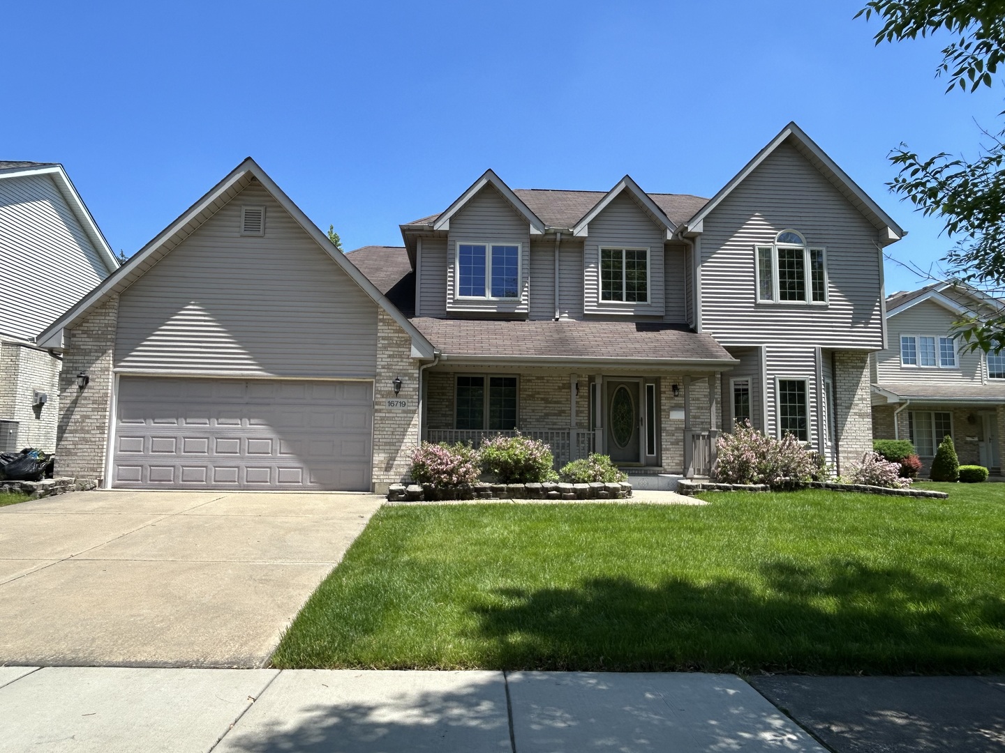 a front view of house with yard and green space